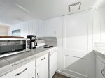 Kitchen with apartment size range, refrigerator, coffee maker, toaster, and microwave